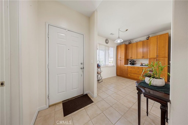 doorway to outside with light tile patterned floors