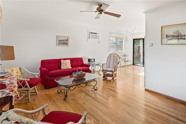 living room featuring an AC wall unit, hardwood / wood-style floors, and ceiling fan