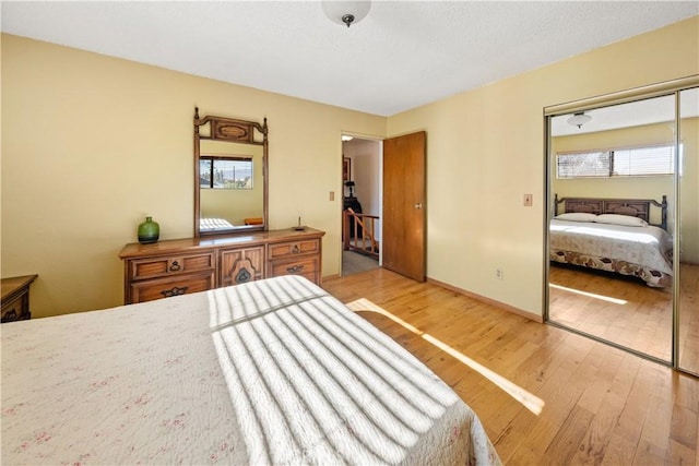 bedroom featuring light hardwood / wood-style floors and a closet