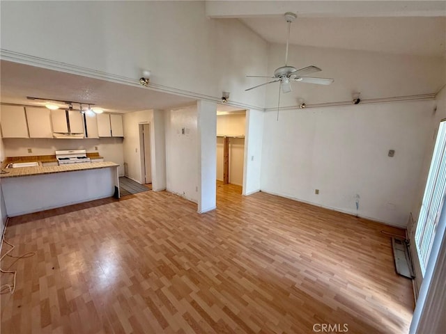 unfurnished living room featuring ceiling fan, light hardwood / wood-style flooring, beam ceiling, and high vaulted ceiling