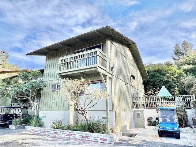 view of side of home featuring a balcony