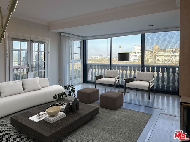 living room featuring french doors, ornamental molding, and hardwood / wood-style flooring