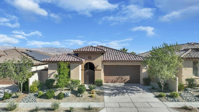 mediterranean / spanish home with a mountain view and a garage