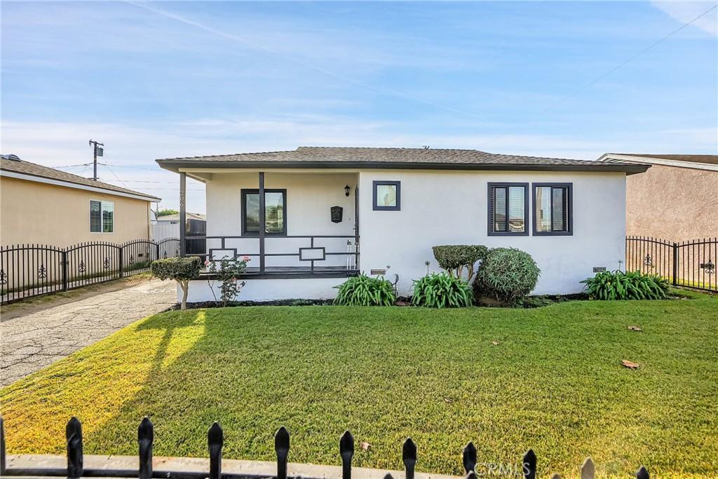 view of front of home with a porch and a front lawn