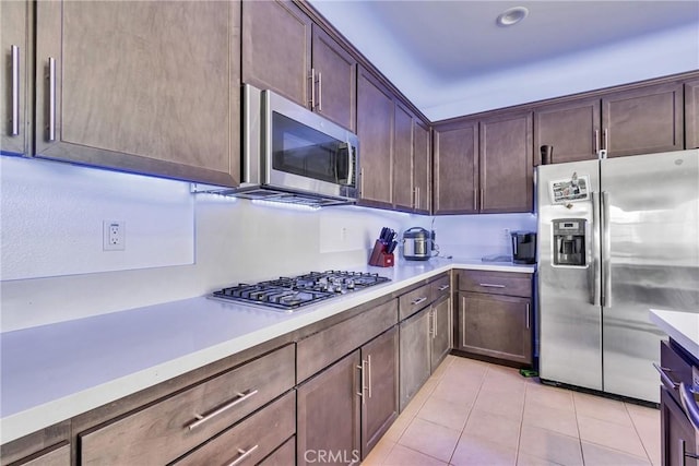 24469 Paxton Ln, Lake Elsinore, CA 92532 - kitchen with appliances with stainless steel finishes, light tile patterned floors, and light countertops