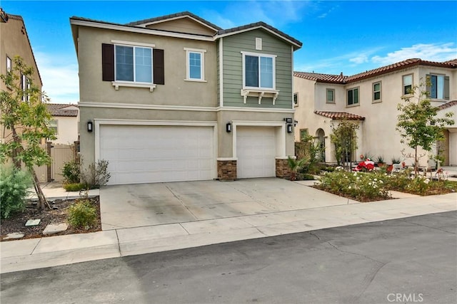 24469 Paxton Ln, Lake Elsinore, CA 92532 - view of front of property featuring an attached garage, stucco siding, concrete driveway, a tiled roof, and stone siding