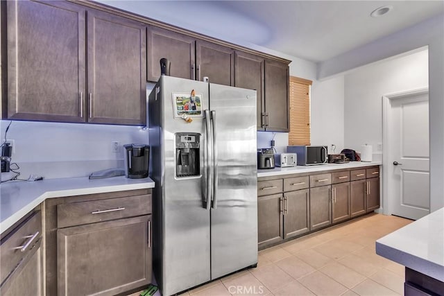 24469 Paxton Ln, Lake Elsinore, CA 92532 - kitchen with stainless steel refrigerator with ice dispenser, light tile patterned flooring, light countertops, and dark brown cabinets