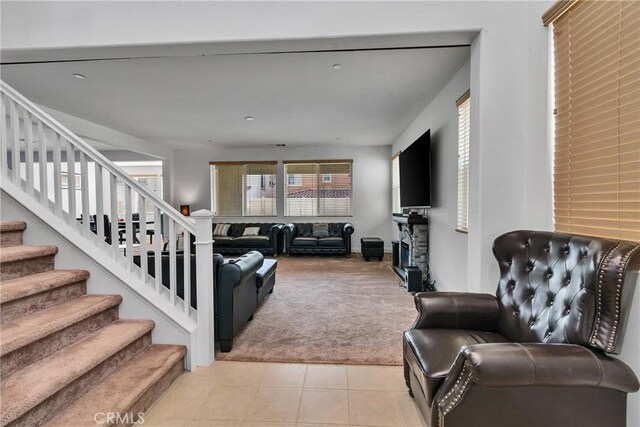 24469 Paxton Ln, Lake Elsinore, CA 92532 - living room with light carpet, stairs, light tile patterned flooring, and a fireplace