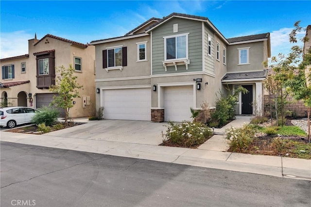 24469 Paxton Ln, Lake Elsinore, CA 92532 - view of front facade with stucco siding, a garage, and driveway