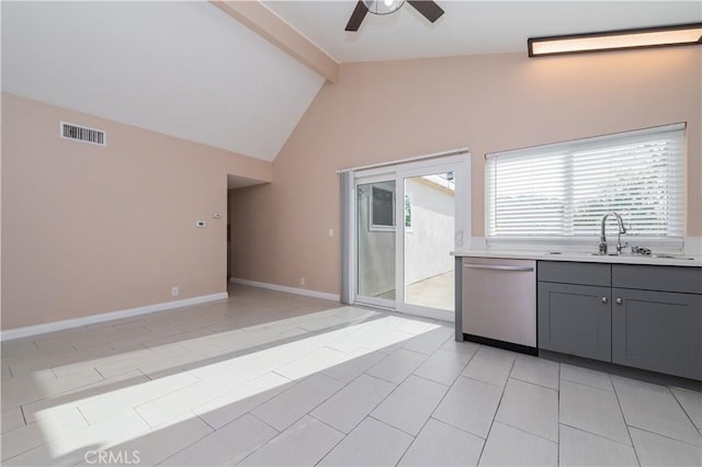 kitchen with stainless steel dishwasher, sink, gray cabinets, lofted ceiling with beams, and light tile patterned floors