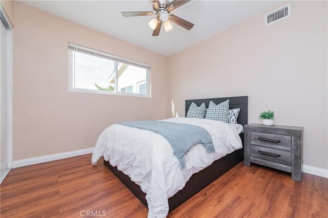 bedroom with ceiling fan and wood-type flooring