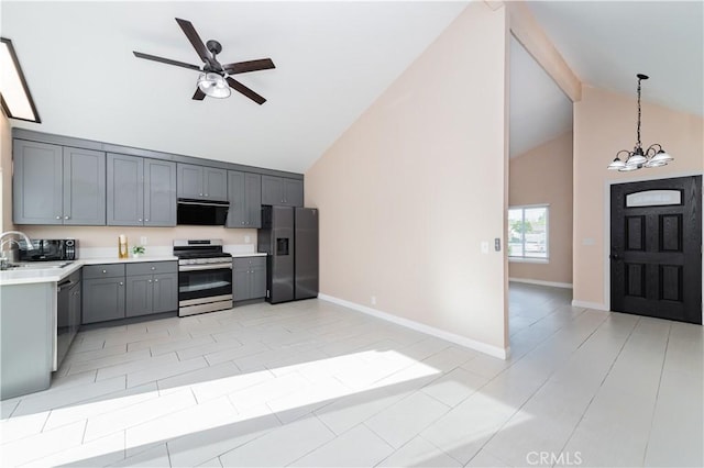 kitchen with exhaust hood, gray cabinets, hanging light fixtures, ceiling fan with notable chandelier, and black appliances