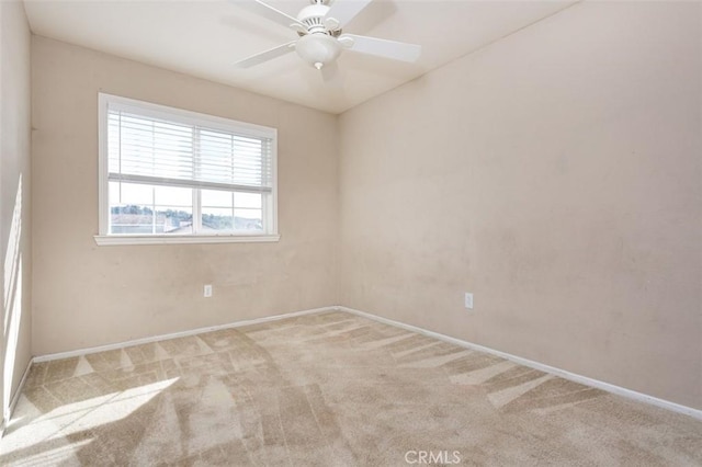 spare room featuring light carpet and ceiling fan