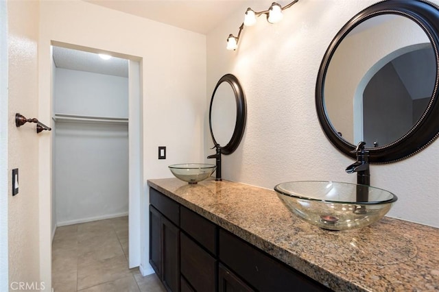 bathroom featuring tile patterned flooring and vanity