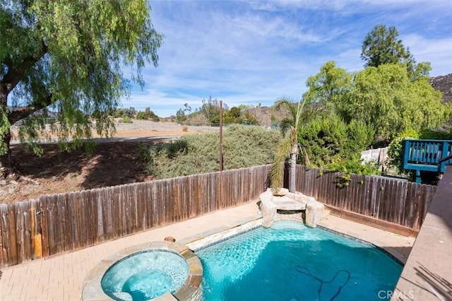 view of swimming pool with an in ground hot tub