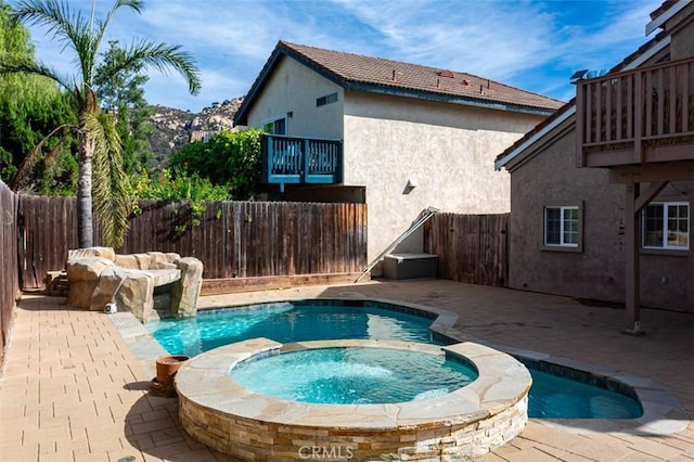 view of pool featuring a patio area and an in ground hot tub