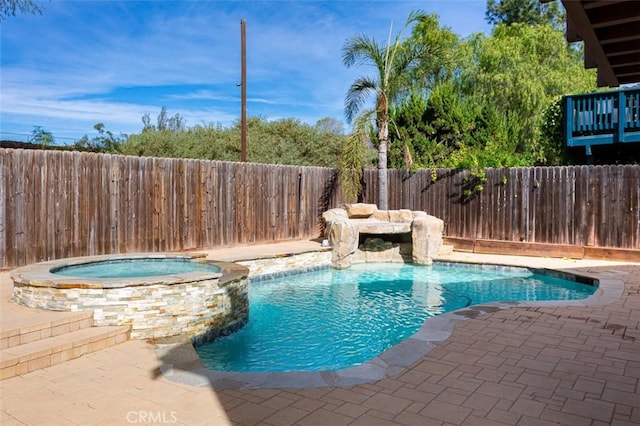 view of swimming pool with an in ground hot tub and a patio