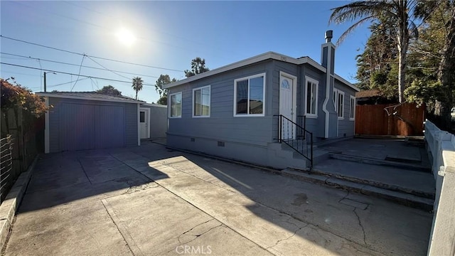 view of side of home featuring a patio and a shed