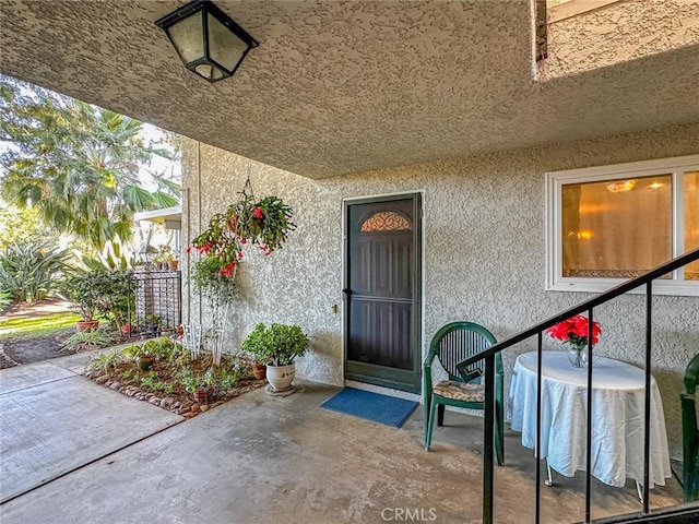 doorway to property with a patio area