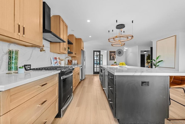 kitchen with a kitchen bar, stainless steel appliances, pendant lighting, a kitchen island, and wall chimney exhaust hood