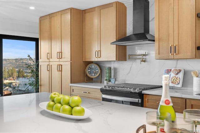 kitchen with tasteful backsplash, light brown cabinetry, wall chimney exhaust hood, and stainless steel range with gas stovetop