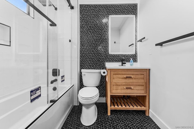 full bathroom with tile patterned floors, combined bath / shower with glass door, vanity, and toilet