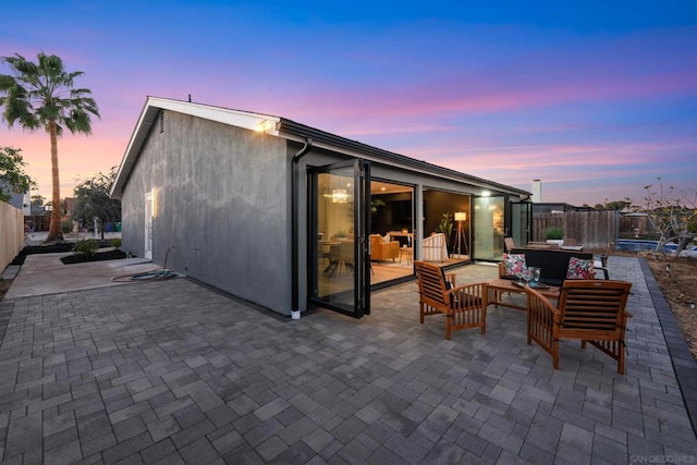 patio terrace at dusk featuring outdoor lounge area