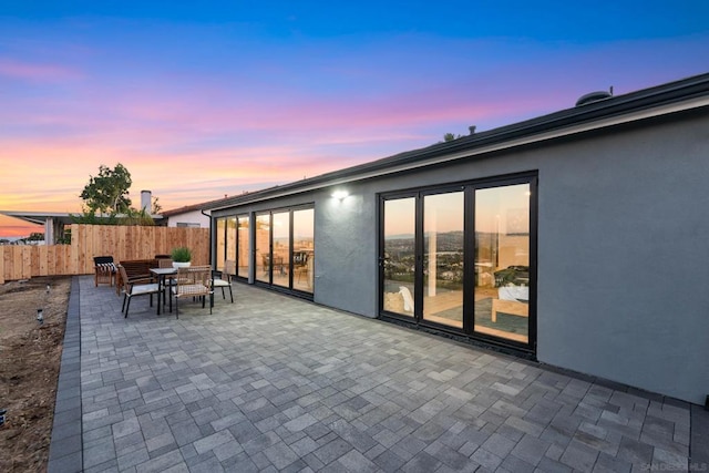 view of patio terrace at dusk