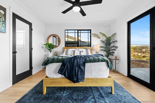 bedroom with ceiling fan, access to exterior, hardwood / wood-style floors, and crown molding