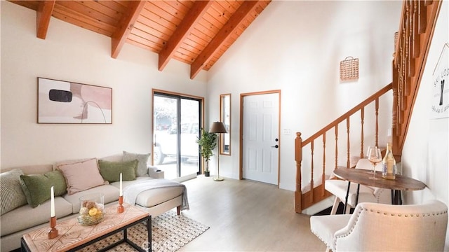 living room with wood ceiling, light wood-type flooring, beamed ceiling, and high vaulted ceiling