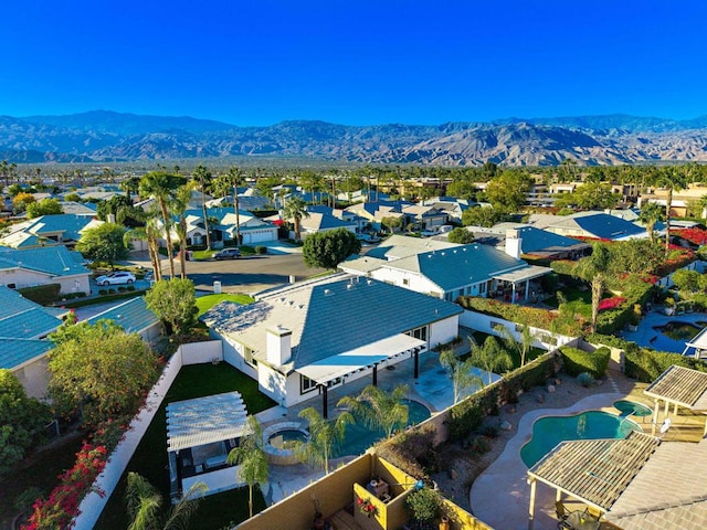 birds eye view of property with a mountain view