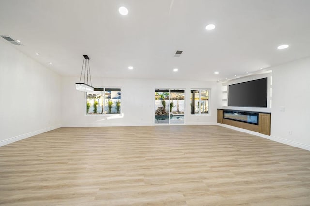 unfurnished living room with light wood-type flooring