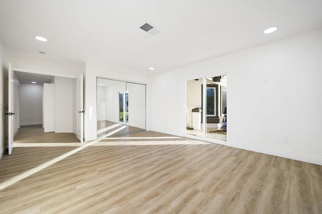 empty room with light hardwood / wood-style floors