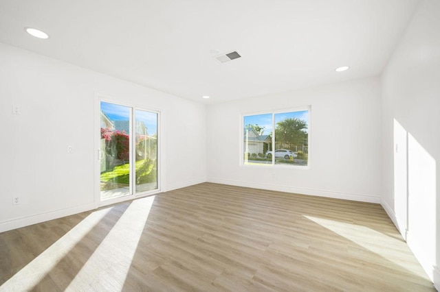 spare room featuring light hardwood / wood-style floors