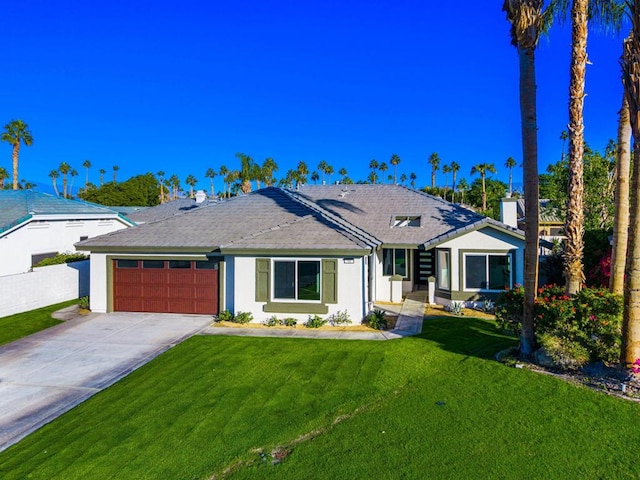 single story home featuring a garage and a front yard