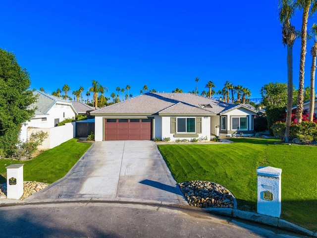 ranch-style home with a front lawn and a garage