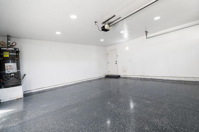 garage featuring secured water heater and a garage door opener