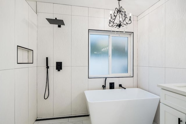 bathroom featuring vanity, a notable chandelier, and shower with separate bathtub