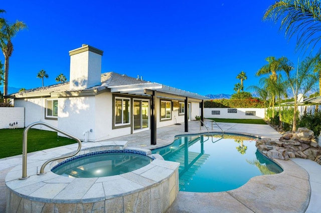 view of pool featuring an in ground hot tub