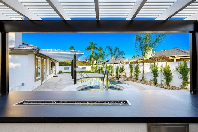 view of patio / terrace featuring a pergola and an in ground hot tub