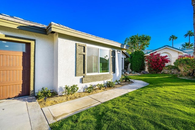 view of side of home featuring a yard