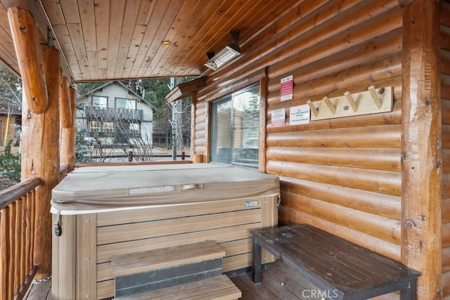 wooden deck with a hot tub