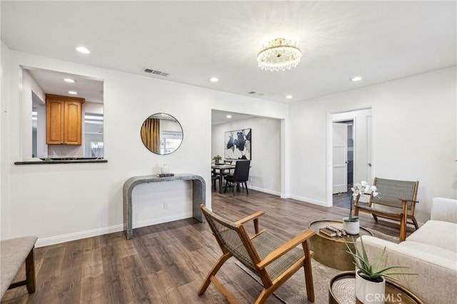 living area with recessed lighting, dark wood-style flooring, and baseboards