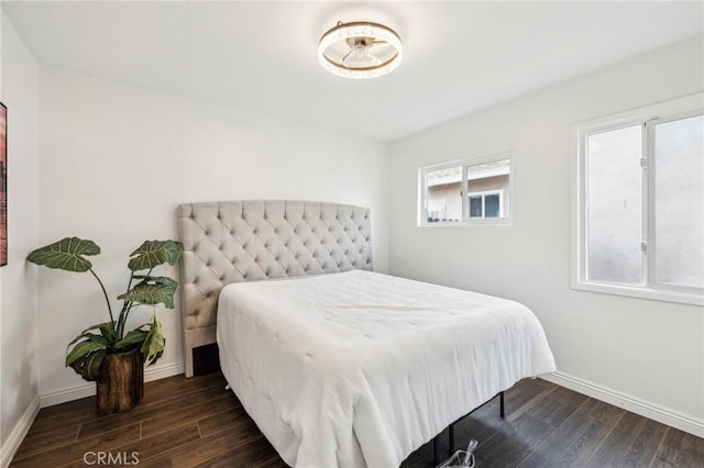 bedroom featuring dark wood-style floors and baseboards