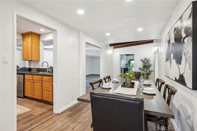 dining room with baseboards, light wood-type flooring, and recessed lighting