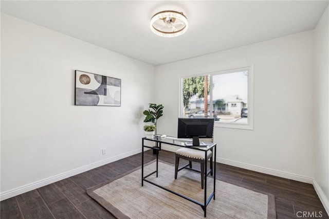 office space featuring dark wood-style flooring and baseboards