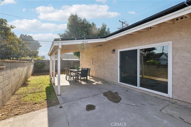 view of patio with a fenced backyard and outdoor dining space