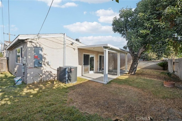 back of house featuring a fenced backyard, a patio, cooling unit, and a yard