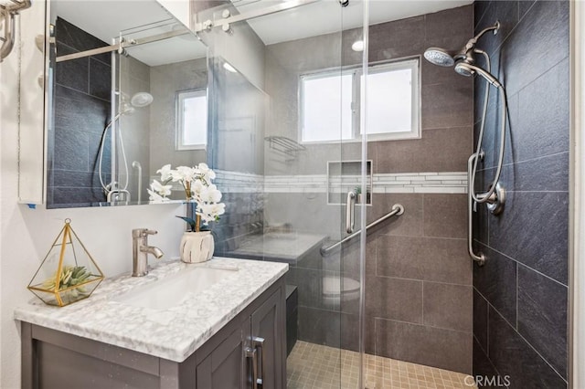 bathroom featuring a stall shower and vanity