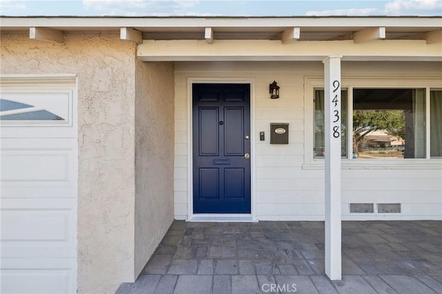 view of exterior entry with stucco siding